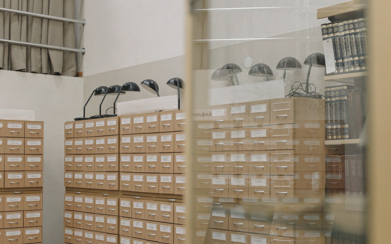 Rows of labelled archive drawers in a records room.